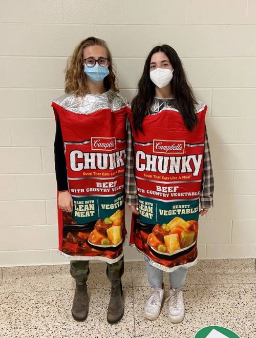 NAEC students Alyssa and Julia don the Campbell's soup costumes for the annual Trick-or-Eat campaign, raising donations for the food bank.